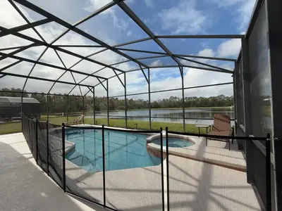 a glass enclosure around a swimming pool on a house at The Villa at Terra Verde in Kissimmee