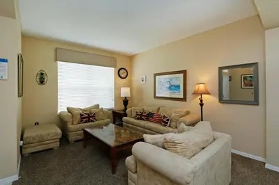 a living room with couches and a coffee table at The Villa at Terra Verde in Kissimmee
