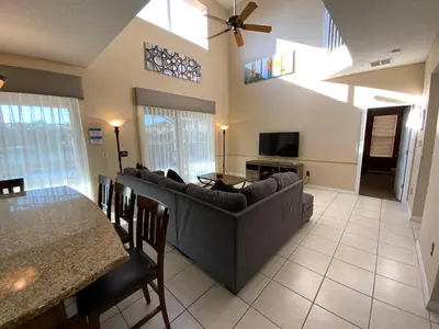 a living room with a couch and a table at The Villa at Terra Verde in Kissimmee
