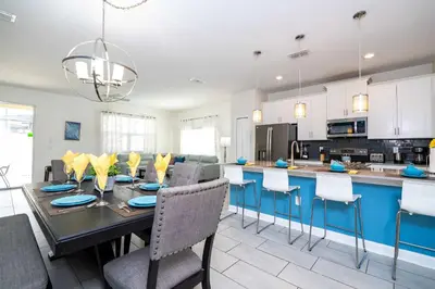 a kitchen and dining room with a table and chairs at Stunning 5 Bd Home w/ Pool Close to Disney 4822 in Kissimmee