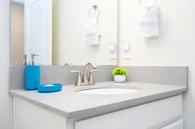 a bathroom counter with a sink and a mirror at Stunning 5 Bd Home w/ Pool Close to Disney 4822 in Kissimmee