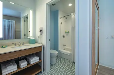 a bathroom with a sink and a toilet and a shower at Universal’s Endless Summer Resort – Dockside Inn and Suites in Orlando