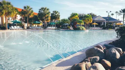 a pool at a resort with a fountain at Holiday Inn Club Vacations At Orange Lake Resort in Orlando