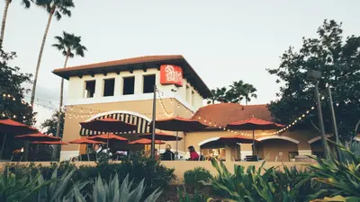 a restaurant with red umbrellas in front of a building at Holiday Inn Club Vacations At Orange Lake Resort in Orlando