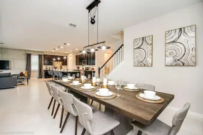 a dining room with a long table and chairs at Sunshine Ridge Loop Villa #258891 Villa in Orlando