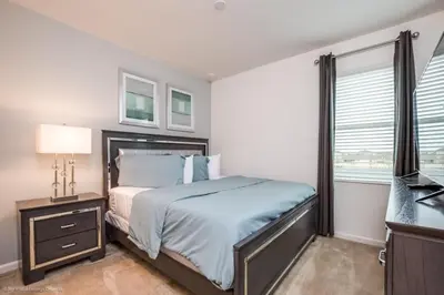 a bedroom with a bed and a desk and a window at Calistoga Avenue Villa #259830 Villa in Kissimmee