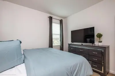 a bedroom with a bed and a flat screen tv at Calistoga Avenue Villa #259830 Villa in Kissimmee
