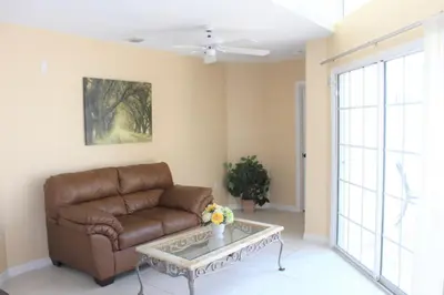 a living room with a couch and a coffee table at Lindfields Reserve #267170 Villa in Kissimmee