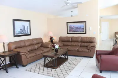a living room with two brown couches and tables at Lindfields Reserve #267170 Villa in Kissimmee