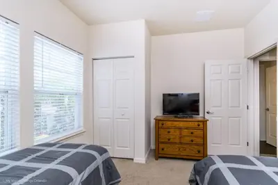 a bedroom with a bed and a tv on a dresser at Lucaya Village Resort Townhome Unit 14 Townhouse in Orlando