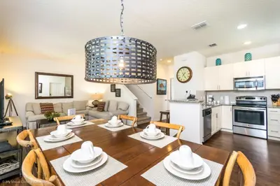 a kitchen and a living room with a table and chairs at Lucaya Village Resort Townhome Unit 14 Townhouse in Orlando