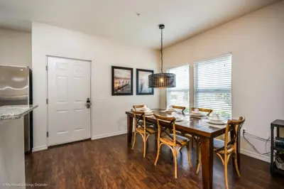 a dining room with a wooden table and chairs at Lucaya Village Resort Townhome Unit 14 Townhouse in Orlando