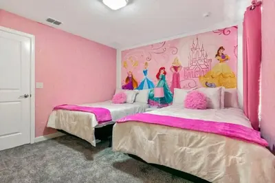 two beds in a pink room with a disney mural at 2901FS - Amazing 8 bedroom at Storey Lake in Kissimmee
