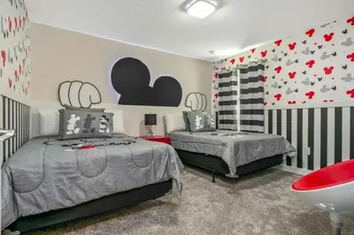two beds in a bedroom with hearts on the wall at 2901FS - Amazing 8 bedroom at Storey Lake in Kissimmee