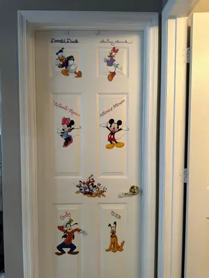 a door with mickey mouse decals on it at House By the Mouse in Kissimmee