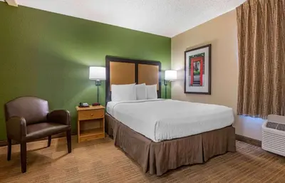 a hotel room with a bed and a chair at Extended Stay America Suites - Orlando - Altamonte Springs in Orlando