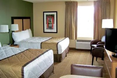 a hotel room with two beds and a television at Extended Stay America Suites - Orlando - Altamonte Springs in Orlando