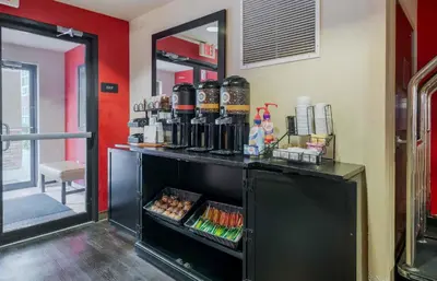 a bar in a restaurant with a red wall at Extended Stay America Suites - Orlando - Lake Mary - 1036 Greenwood Blvd in Lake Mary