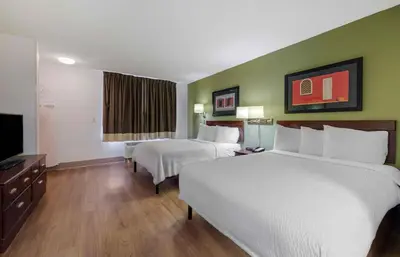 a hotel room with two beds and a flat screen tv at Extended Stay America Suites - Orlando - Lake Mary - 1036 Greenwood Blvd in Lake Mary