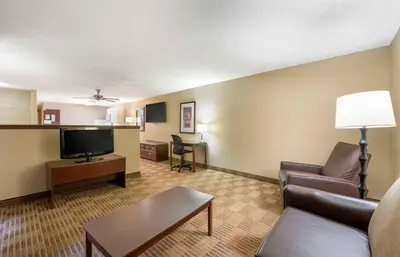 a living room with a couch and a flat screen tv at Extended Stay America Suites - Orlando - Lake Mary - 1036 Greenwood Blvd in Lake Mary