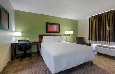 a hotel room with a large white bed and a desk at Extended Stay America Suites - Orlando - Lake Mary - 1036 Greenwood Blvd in Lake Mary