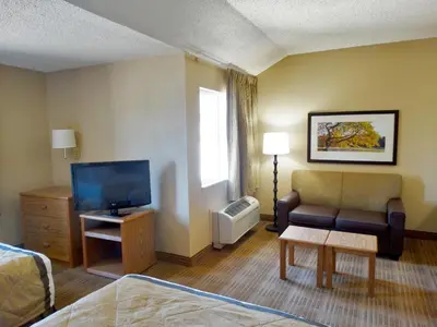 a living room with a couch and a tv at Extended Stay America Select Suites - Orlando - Lake Mary - 1040 Greenwood Blvd in Lake Mary