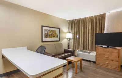 a living room with a couch and a flat screen tv at Extended Stay America Select Suites - Orlando - Lake Mary - 1040 Greenwood Blvd in Lake Mary