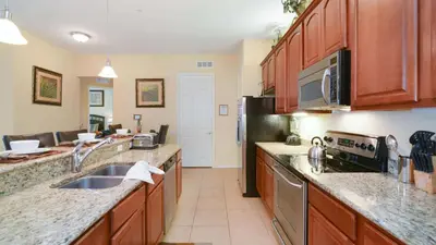 a kitchen with a sink and a microwave at Chantilly Condo - closer to Disney and Universal in Orlando