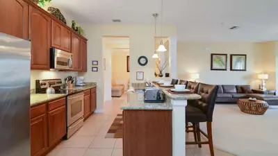 a kitchen and a living room with a kitchen and a living room at Chantilly Condo - closer to Disney and Universal in Orlando