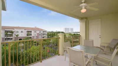 a balcony with a table and chairs and a view at Chantilly Condo - closer to Disney and Universal in Orlando