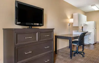 a room with a desk and a tv on top of a dresser at Extended Stay America Suites - Orlando - Orlando Theme Parks - Major Blvd in Orlando