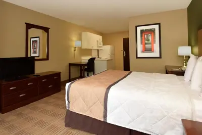 a hotel room with a bed and a television at Extended Stay America Suites - Orlando - Orlando Theme Parks - Major Blvd in Orlando