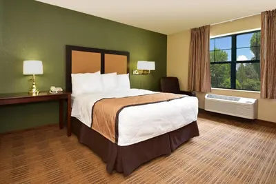 a hotel room with a large bed and a window at Extended Stay America Suites - Orlando - Orlando Theme Parks - Major Blvd in Orlando