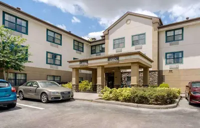 a car parked in a parking lot in front of a building at Extended Stay America Select Suites - Orlando - Maitland - 1760 Pembrook Dr in Orlando