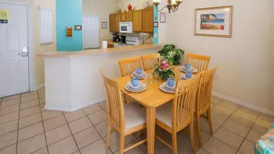 a kitchen and dining room with a table and chairs at The Floridian 3 bed townhouse at Emerald Island Resort in Kissimmee