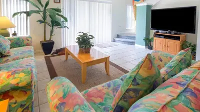 a living room with two couches and a table at The Floridian 3 bed townhouse at Emerald Island Resort in Kissimmee