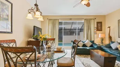 a living room with a couch and a table at Minnies Townhouse in Windsor Palms Resort in Kissimmee