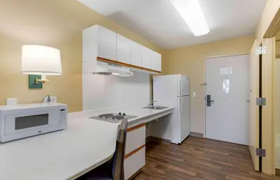a kitchen with a sink and a refrigerator at Extended Stay America Select Suites - Orlando - Southpark - Equity Row in Orlando