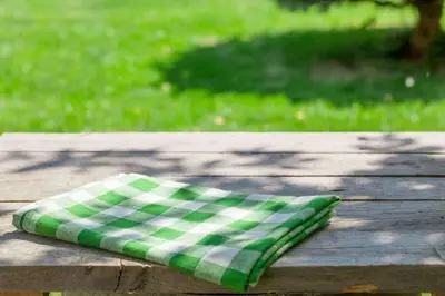 a green and white pillow sitting on a wooden table at Extended Stay America Select Suites - Orlando - Southpark - Equity Row in Orlando
