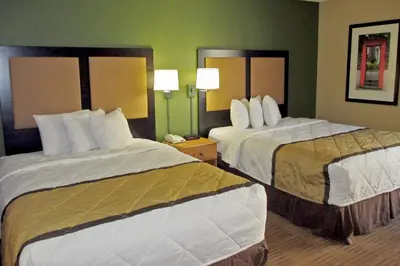 a hotel room with two beds and two lamps at Extended Stay America Select Suites - Orlando - Southpark - Equity Row in Orlando
