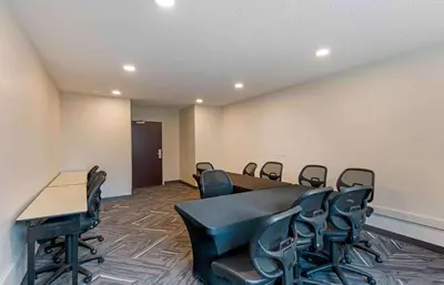 a conference room with a table and chairs at Extended Stay America Select Suites - Orlando - Maitland - Summit Tower Blvd in Orlando