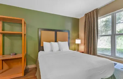 a bedroom with a large bed and a window at Extended Stay America Select Suites - Orlando - Maitland - Summit Tower Blvd in Orlando