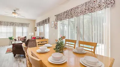 a dining room with a table and a living room at Bikini on the Beach at Terra Verde Resort in Kissimmee