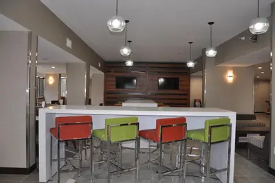a lobby with a bar with colorful chairs at Nobile Hotel Parkway at Celebration Orlando Very Close to Disney Theme Parks in Orlando