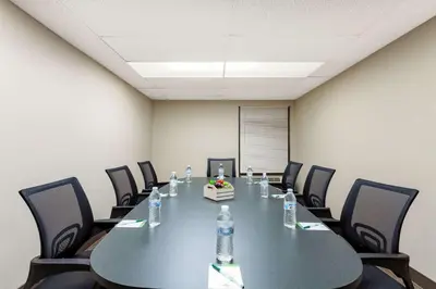 a conference room with a table and chairs and water bottles at Nobile Hotel Parkway at Celebration Orlando Very Close to Disney Theme Parks in Orlando