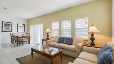 a living room with a couch and a table at Encantada Rose - a 4 bed townhouse near Disney in Kissimmee
