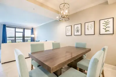 a dining room with a wooden table and chairs at Siena at Bella Collina in Montverde