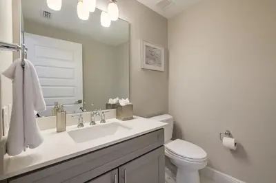 a white bathroom with a sink and a toilet at Siena at Bella Collina in Montverde