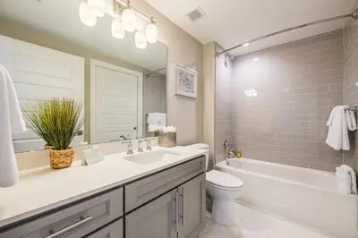 a bathroom with a sink and a toilet and a tub at Siena at Bella Collina in Montverde