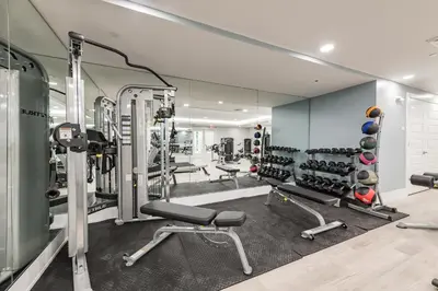 a gym with lots of treadmills and weights at Siena at Bella Collina in Montverde